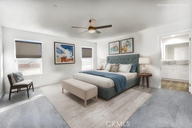 bedroom with ceiling fan, connected bathroom, and light hardwood / wood-style flooring