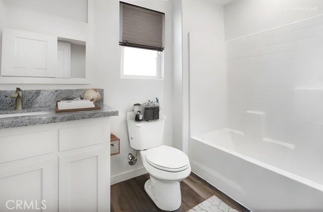 full bathroom featuring shower / bath combination, wood-type flooring, vanity, and toilet