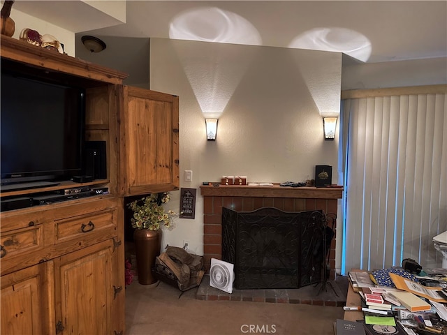 living room with carpet and a brick fireplace