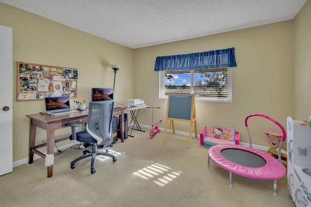 carpeted office featuring a textured ceiling