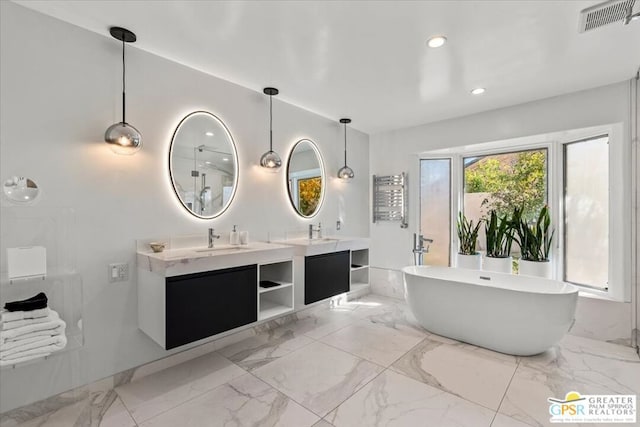 bathroom featuring vanity and a tub