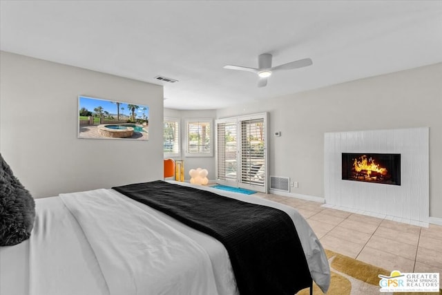 bedroom featuring ceiling fan and light tile patterned flooring