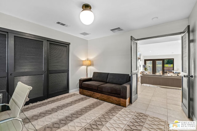 tiled living room featuring french doors