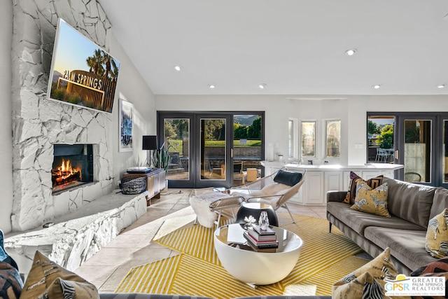 living room featuring a fireplace, french doors, and plenty of natural light