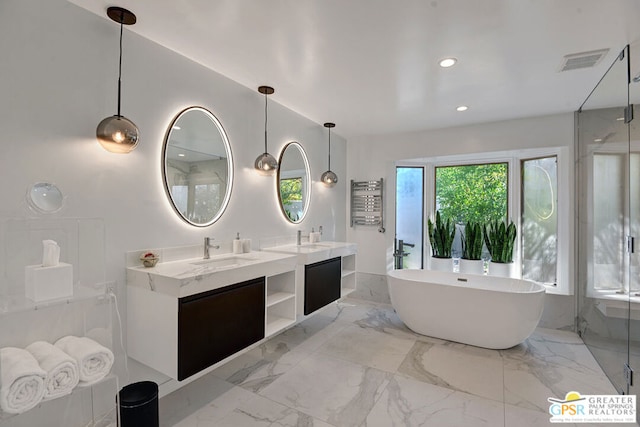 bathroom featuring a washtub and vanity