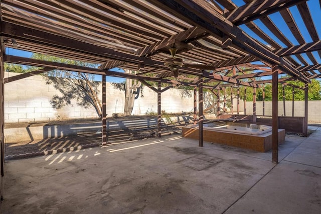 view of patio / terrace featuring a pergola and an outdoor hot tub