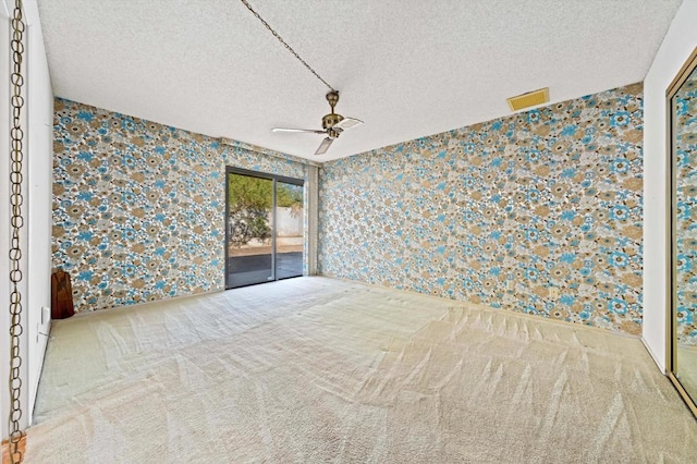 interior space featuring a textured ceiling, access to outside, and ceiling fan