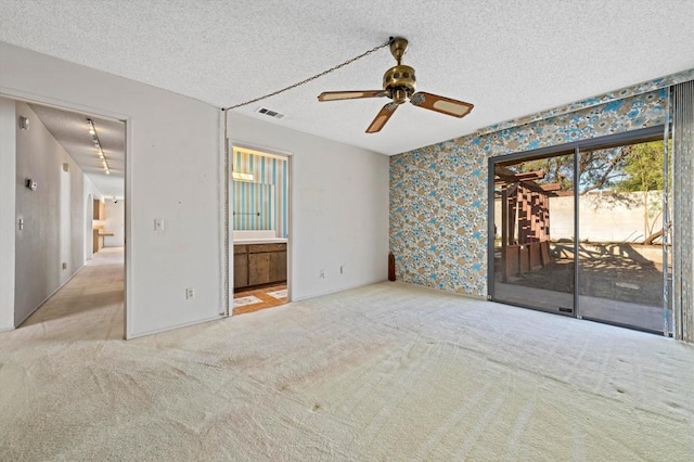 unfurnished bedroom with access to outside, ceiling fan, light carpet, and a textured ceiling