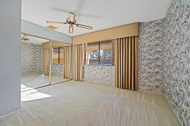 spare room with ceiling fan and a textured ceiling