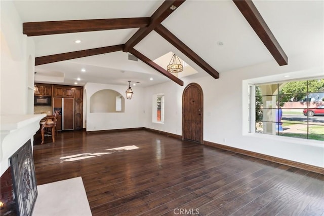 unfurnished living room featuring dark hardwood / wood-style flooring and lofted ceiling with beams