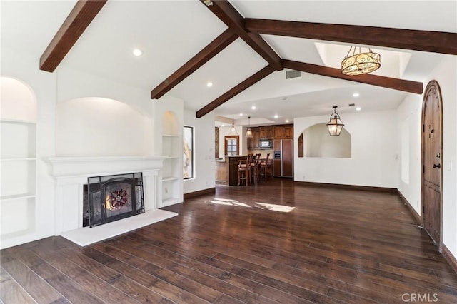 unfurnished living room featuring vaulted ceiling with beams, dark wood-type flooring, and a chandelier