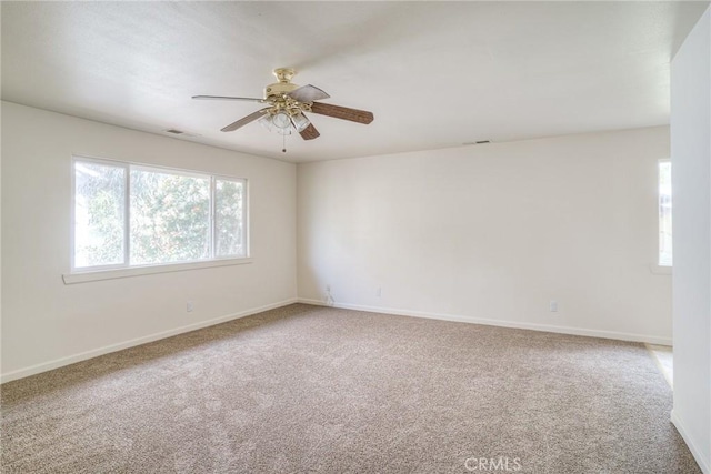 unfurnished room featuring ceiling fan and carpet floors