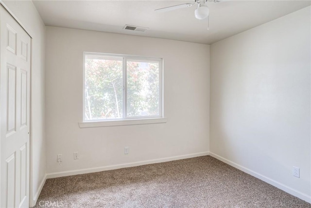 unfurnished room featuring ceiling fan and carpet floors