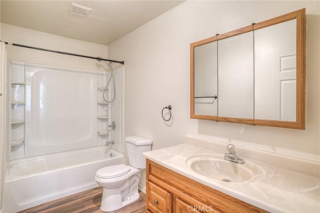 full bathroom with shower / washtub combination, vanity, wood-type flooring, and toilet