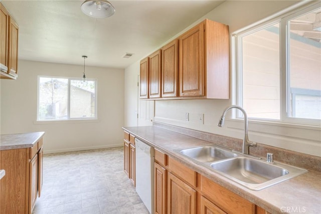 kitchen featuring dishwasher, hanging light fixtures, and sink