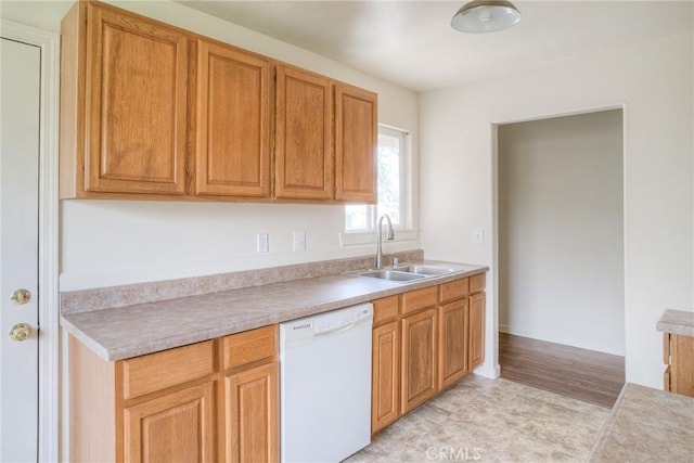 kitchen with dishwasher, light wood-type flooring, and sink