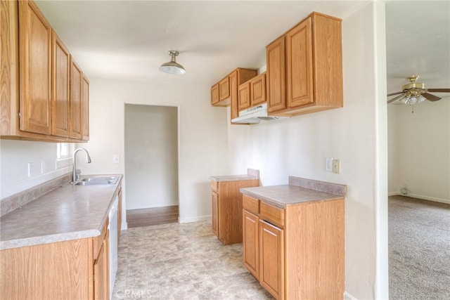 kitchen featuring ceiling fan, light colored carpet, sink, and dishwasher