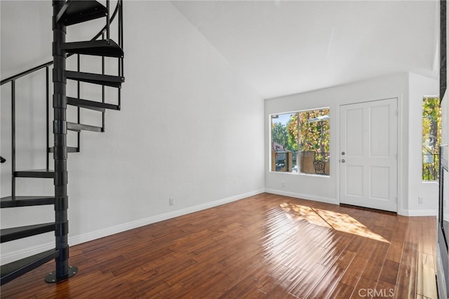 foyer with hardwood / wood-style floors and vaulted ceiling