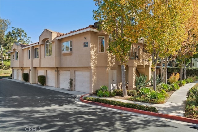 multi unit property featuring a garage