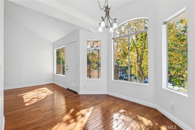 unfurnished dining area with hardwood / wood-style flooring and a chandelier