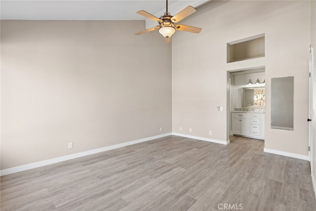 unfurnished bedroom featuring ceiling fan, light hardwood / wood-style flooring, and high vaulted ceiling