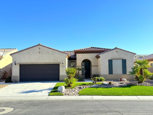 mediterranean / spanish house with a garage