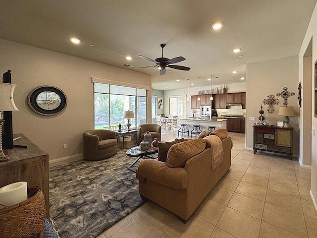 tiled living room featuring ceiling fan