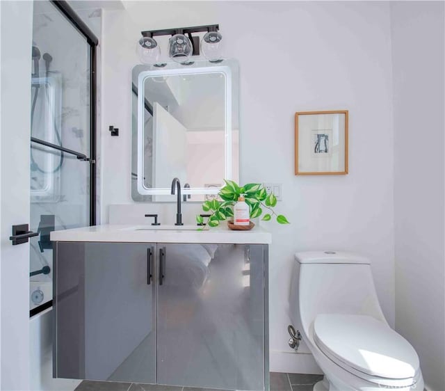 bathroom featuring tile patterned flooring, vanity, toilet, and walk in shower