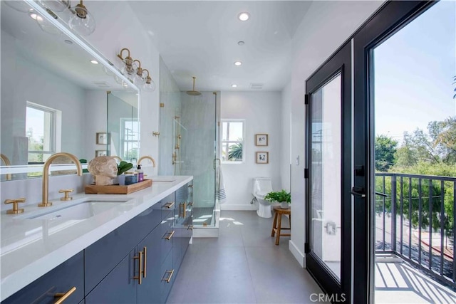 bathroom featuring vanity, toilet, and a shower with door