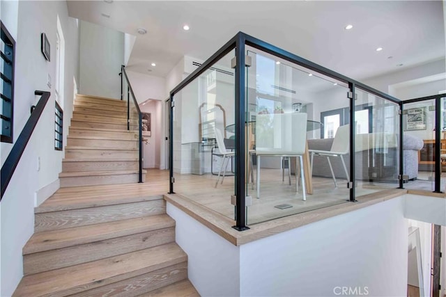 staircase with hardwood / wood-style floors