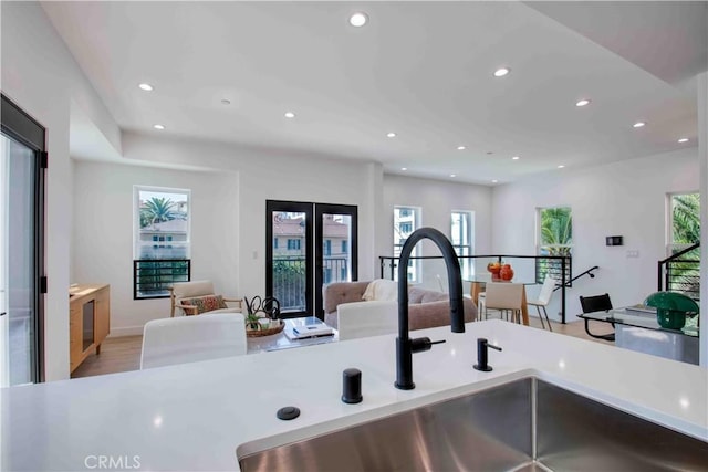 interior space with light wood-type flooring, a wealth of natural light, and sink