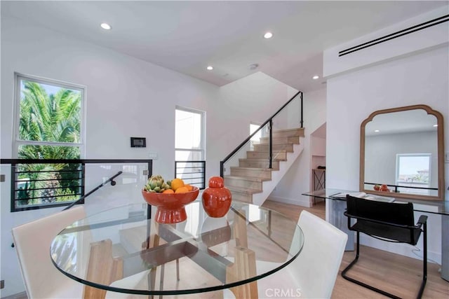 dining space featuring a wealth of natural light and light wood-type flooring