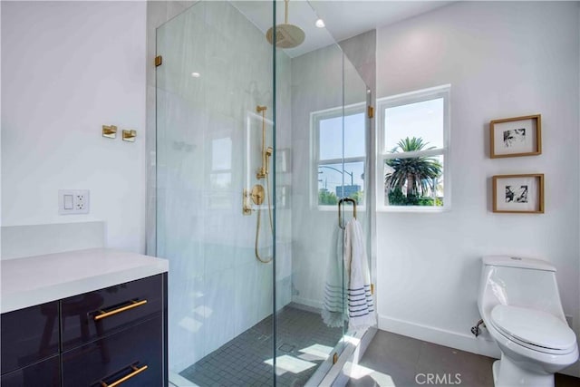 bathroom with tile patterned flooring, toilet, and a shower with shower door