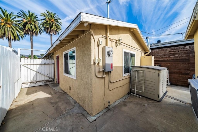 view of home's exterior featuring fence, a patio, and stucco siding