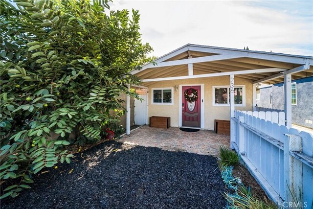 view of exterior entry with a porch