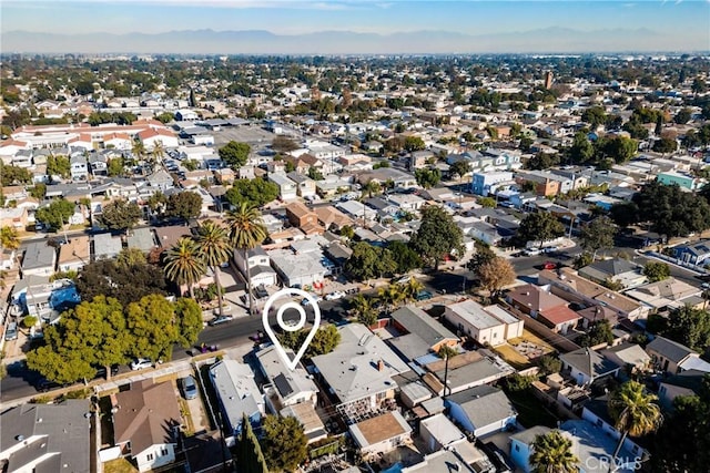 birds eye view of property with a mountain view and a residential view