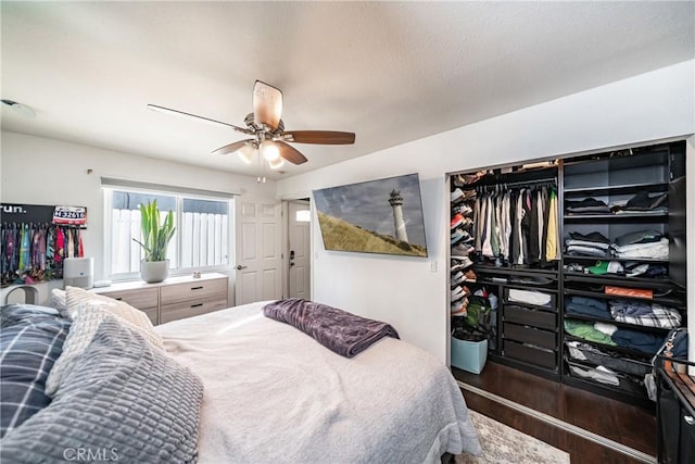 bedroom with wood finished floors and a ceiling fan