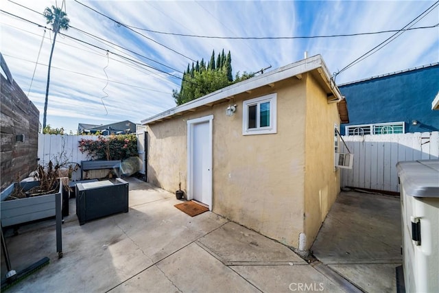 view of outbuilding with a fenced backyard and an outdoor structure