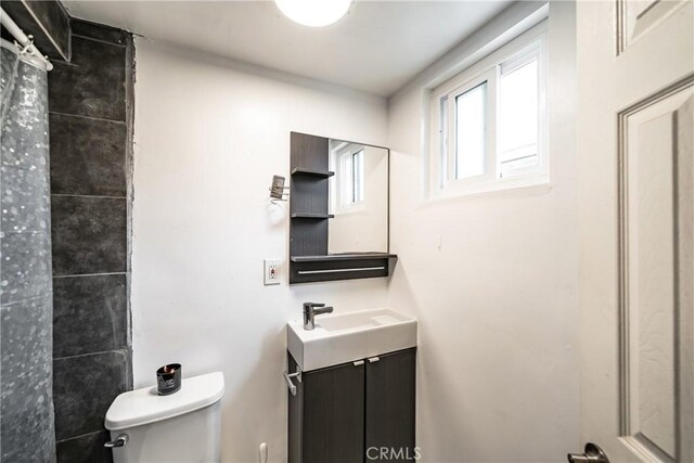 bathroom featuring vanity and toilet