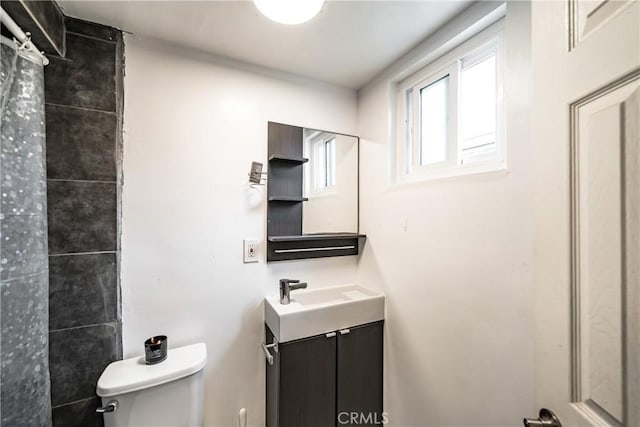 bathroom featuring toilet and vanity