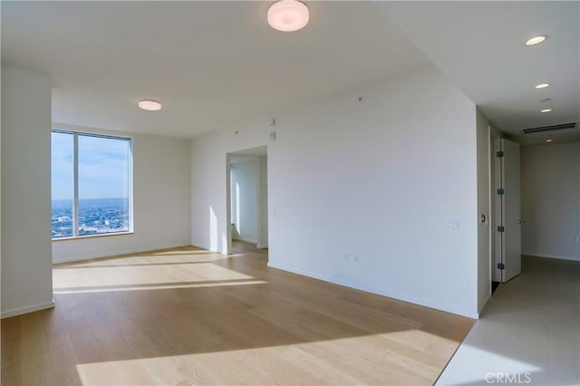 unfurnished room featuring light wood-type flooring