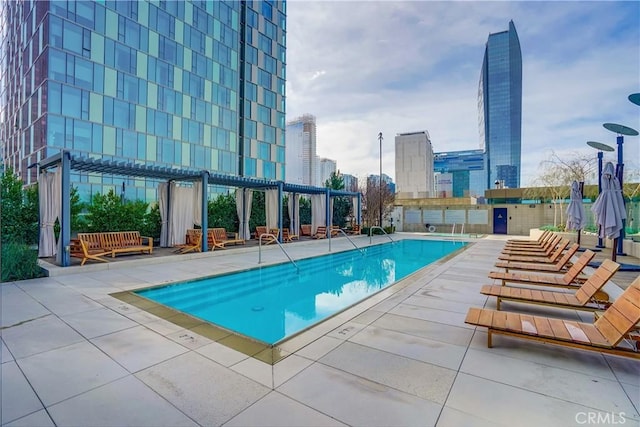 view of swimming pool with a pergola and a patio