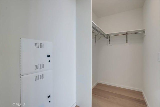 walk in closet with light wood-type flooring