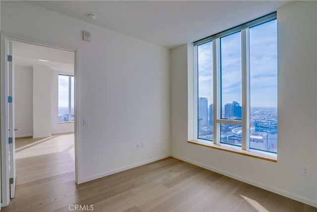 empty room with light hardwood / wood-style flooring