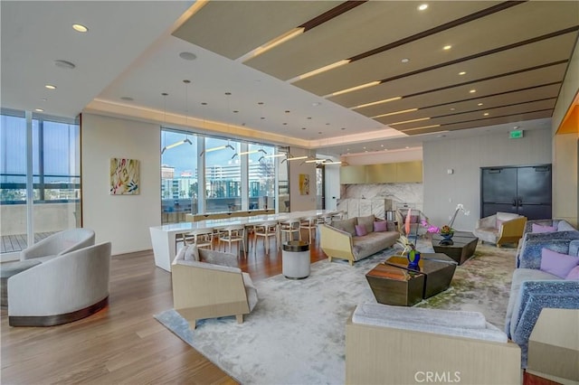 interior space featuring a tray ceiling and hardwood / wood-style flooring