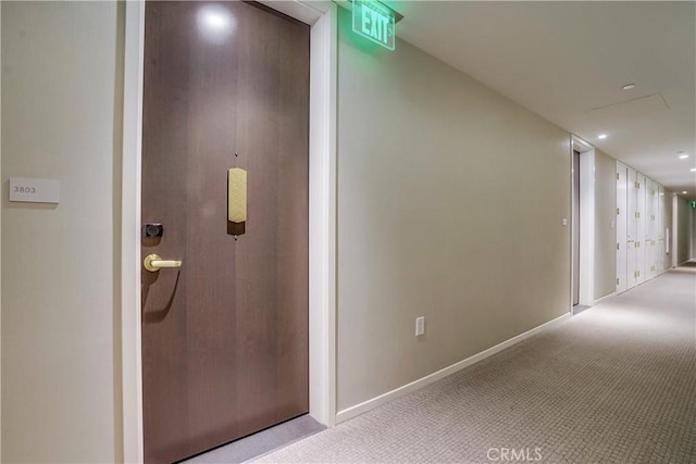 corridor featuring light colored carpet