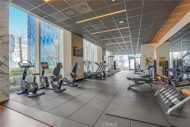 gym with a wall of windows