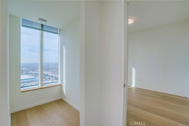 spare room with light hardwood / wood-style flooring