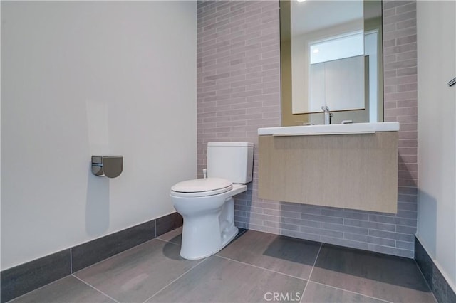 bathroom with tile patterned flooring, vanity, and toilet