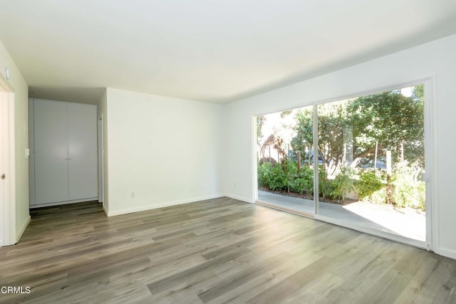 unfurnished room with hardwood / wood-style flooring